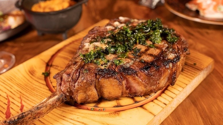 prepared steak served on board at Primal Steakhouse