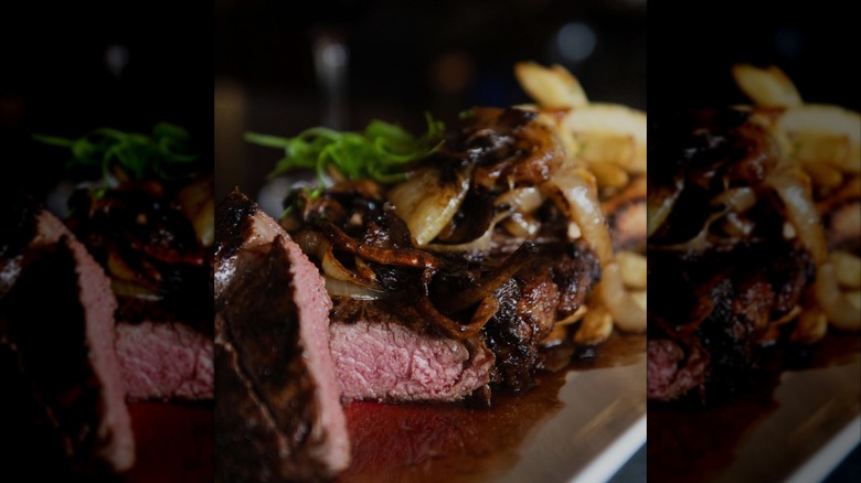 steak with onions at Hanover Street Chophouse