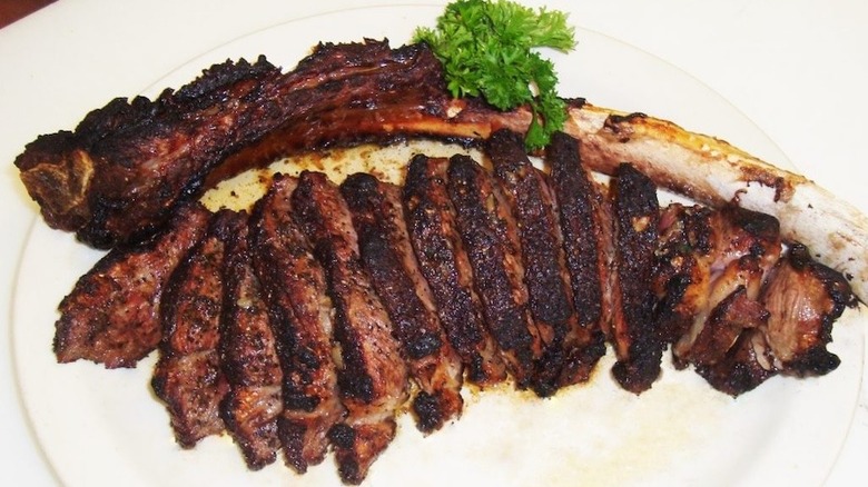 sliced steak with bone at River Palm Terrace