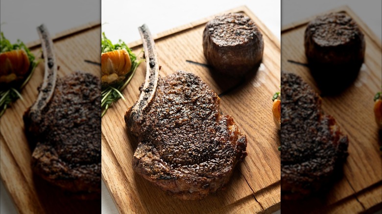 two different prepared steaks on a cutting board at Market Steer Steakhouse