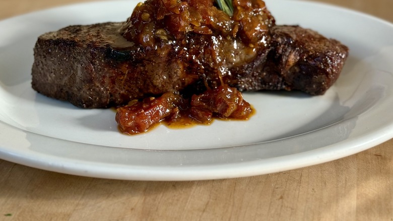 prepared steak with sauce on a plate at Folk's Folly