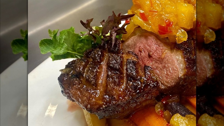 close-up of a prepared steak dish with carrots on a plate at Bookbinder's