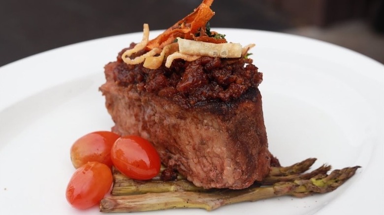 steak plated with cherry tomatoes and asparagus tips at The Wonder Bar