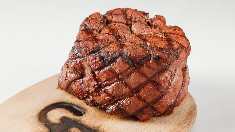 steak on branded board at The Gun Barrel Steak and Game House