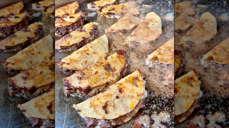 Multiple beef tacos on griddle