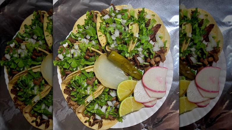 Plate of six beef tacos with vegetables