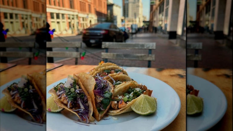 tacos in fried shells sitting on a table outside