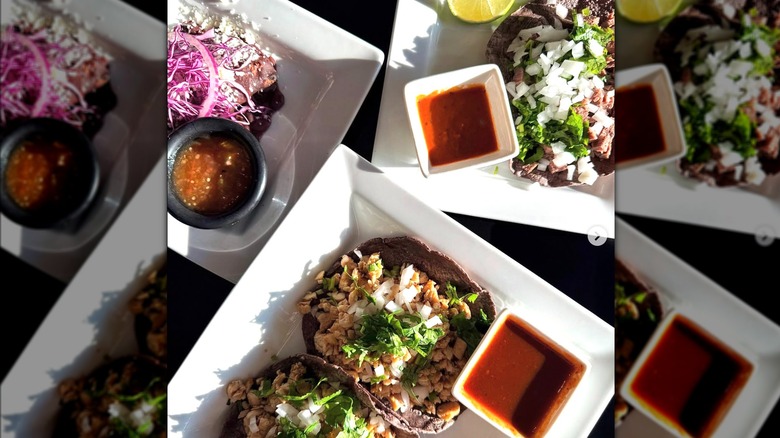 top down view of three plates of tacos and salsa on white plates