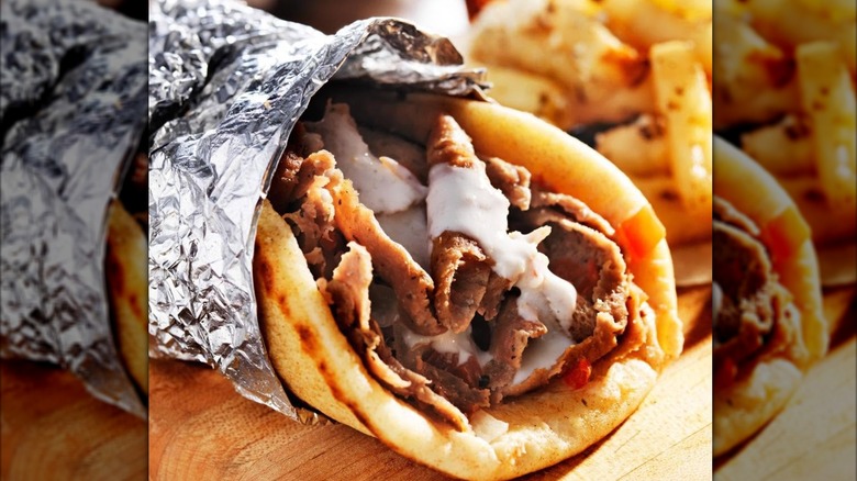 Gyro from Mama's Gyros Grill with fries on a wooden platter