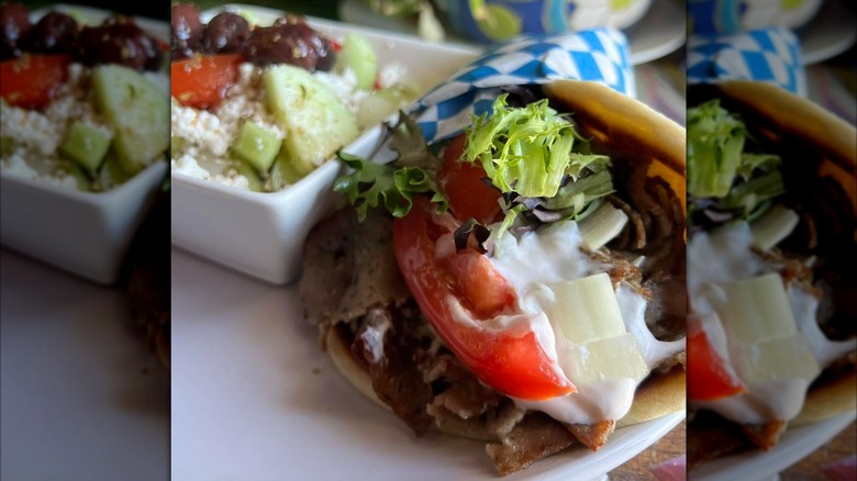 Gyro on a white plate with a side of Greek salad from Sofia's Greek Bistro