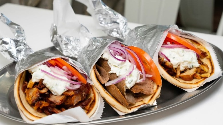 Three Gyros on a plate from Greek Village Grille