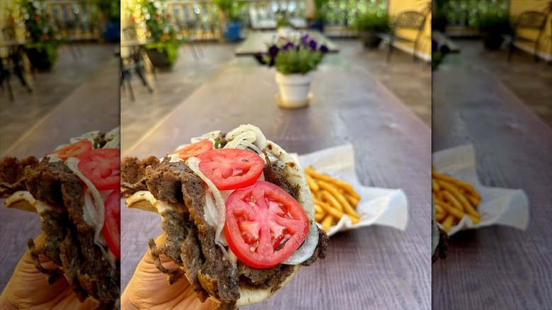 Hand holding a gyro from Parthenon Gyros