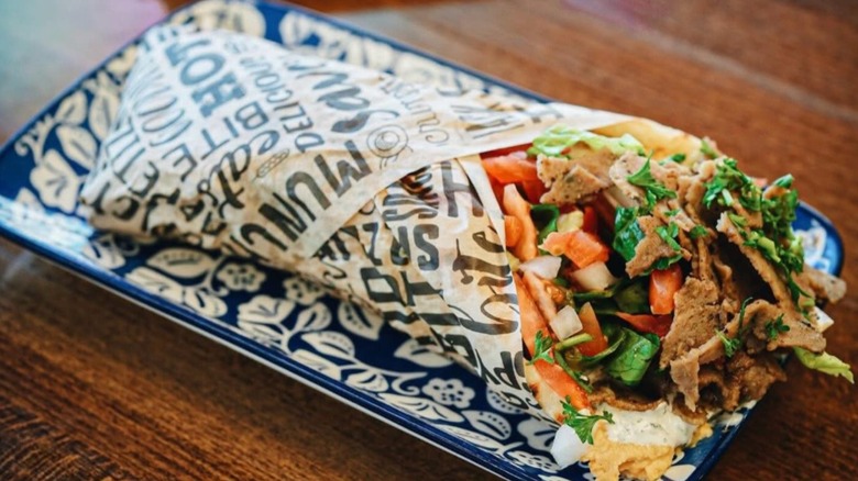 Gyro from Sweet Zoey Mediterranean Restaurant wrapped and placed on a plate