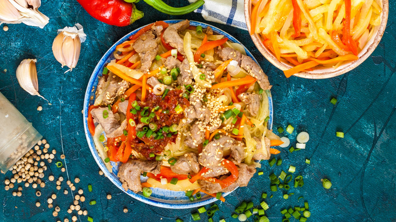 Chinese watermelon rind stir-fry with meat and chilies garnished with scallions and sesame seeds