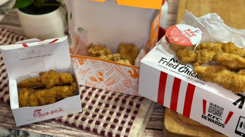KFC, Chick-fil-A & Popeyes open takeout boxes with chicken tenders inside