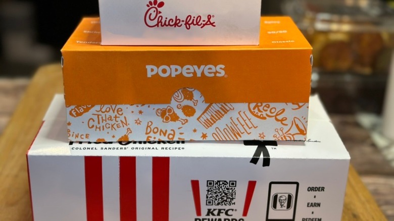 KFC, Chick-fil-A & Popeyes takeout boxes stacked
