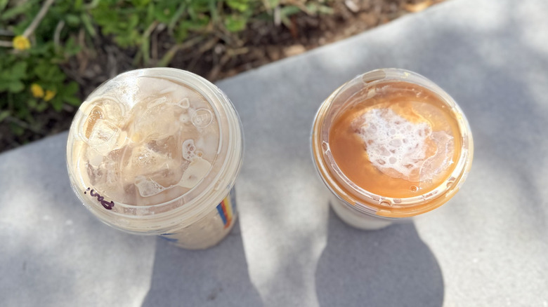Top view of Dutch Bros Golden Eagle and Starbucks Iced Caramel Macchiato in plastic to-go cups