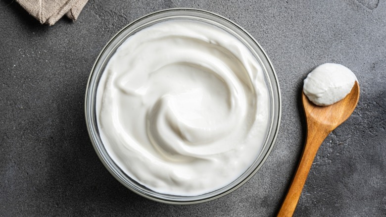 A bowl of Greek yogurt with a wooden spoon
