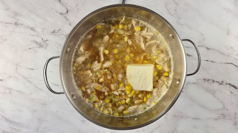cream cheese, beans, and vegetables in a pot of liquid