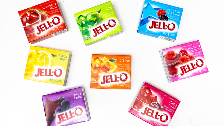 Boxes of different flavors of Jell-O mix scattered on a white surface