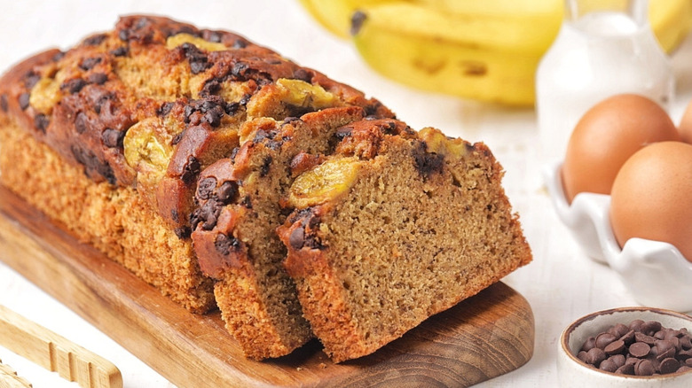 Sliced banana bread topped with sliced bananas and chocolate chips