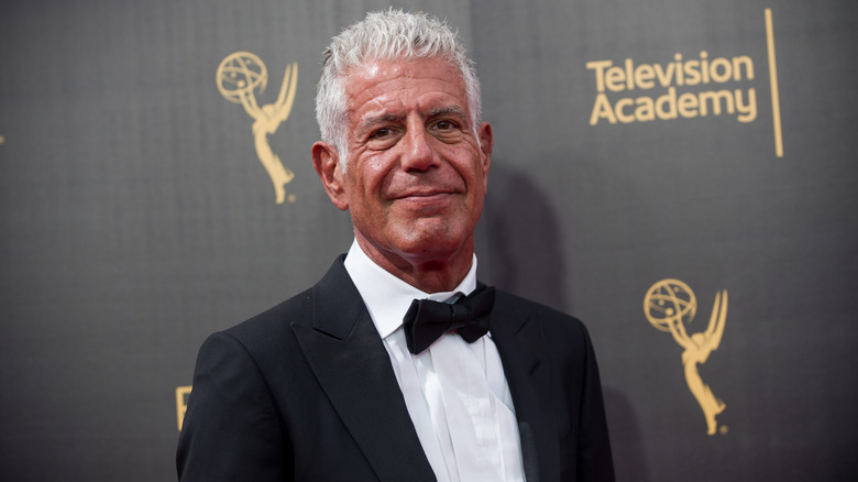 A headshot of Anthony Bourdain smiling at a red carpet event
