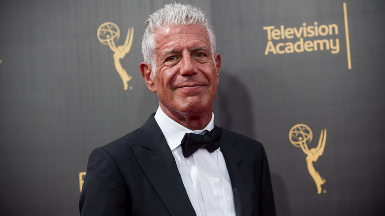 Anthony Bourdain smiles in a tuxedo on the Emmys red carpet