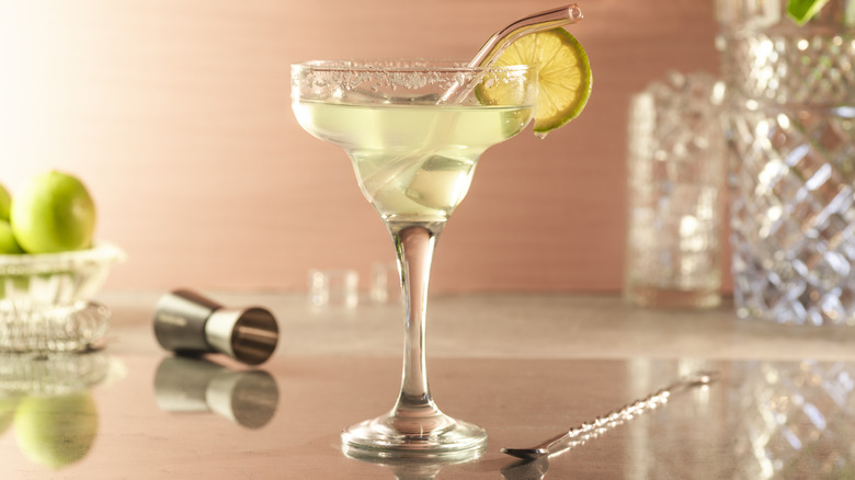 Classic margarita on a table with limes