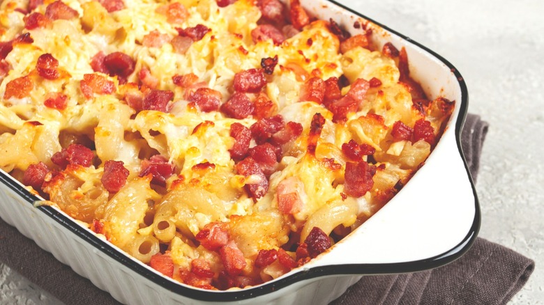 Baked macaroni and cheese with bacon in a casserole dish