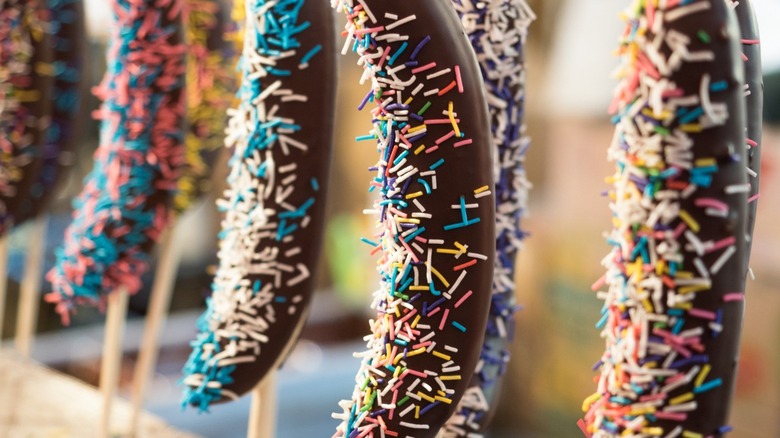 Chocolate covered bananas with sprinkles.