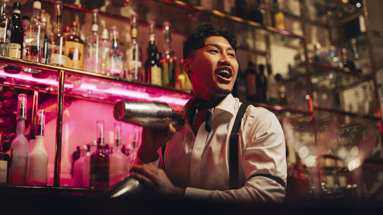 a bartender mixes cocktails