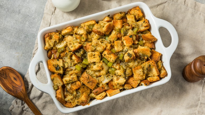 White baking pan with bread stuffing on towel