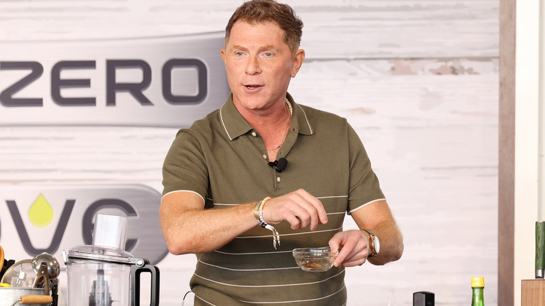 Bobby Flay gives a cooking demo at an event