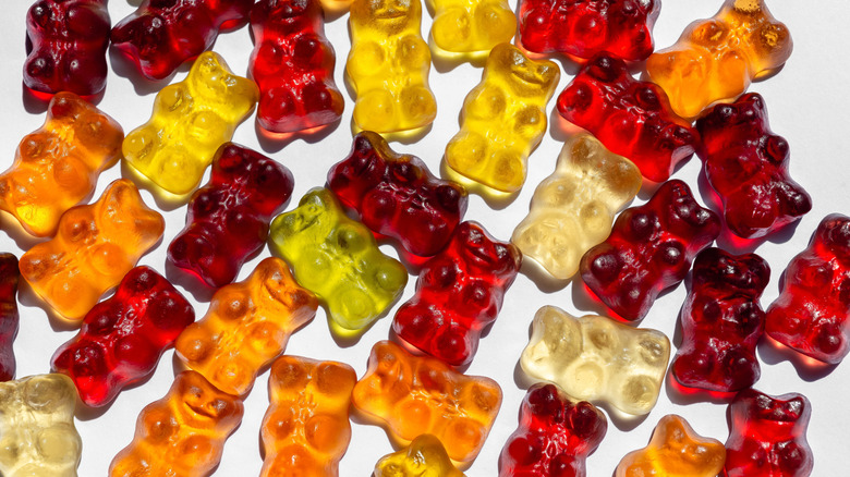 Top view of assorted gummy bears on white background