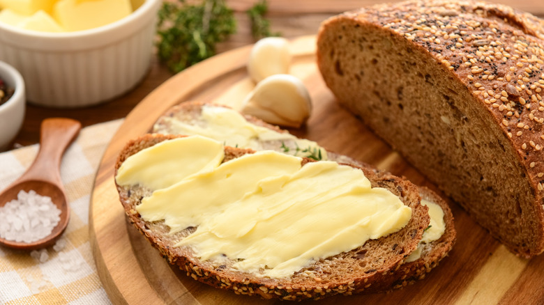 Bread loaf with buttered toast slice