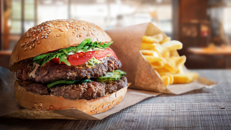 A burger and fries on a table in a restaurant