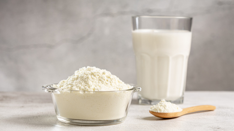 bowl of powdered milk with a glass of reconstituted milk
