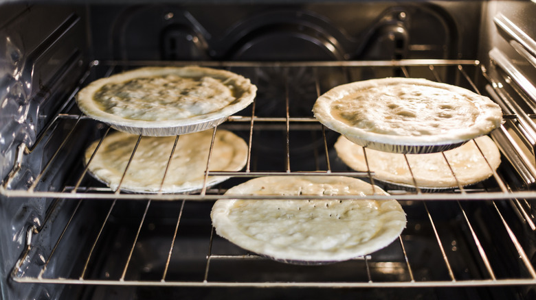 five pies baking in an oven