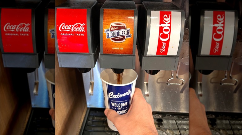 Filling a cup with Culver's root beer from a soda fountain