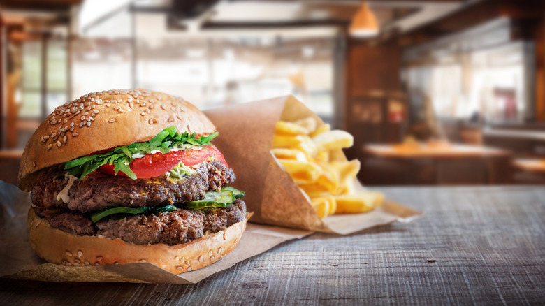 A burger and fries on a table in a restaurant