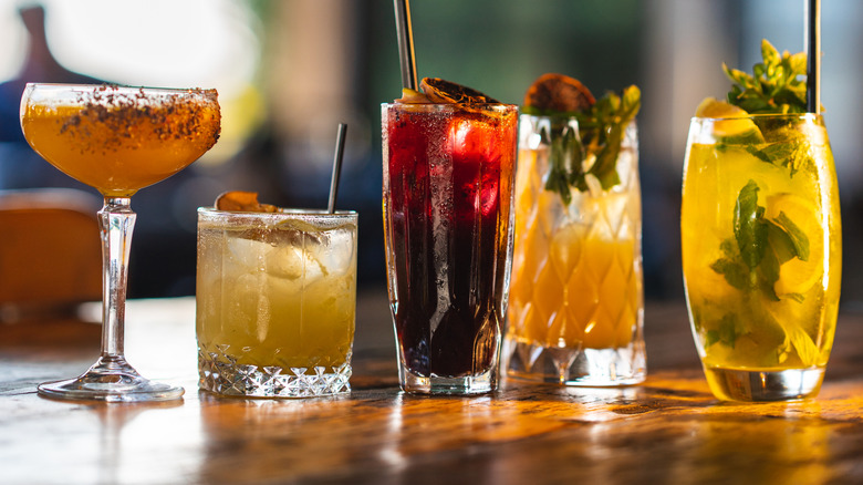 Various cocktails lined up on bar
