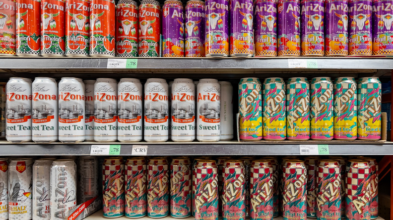 Colorful cans of AriZona iced tea on a grocery shelf