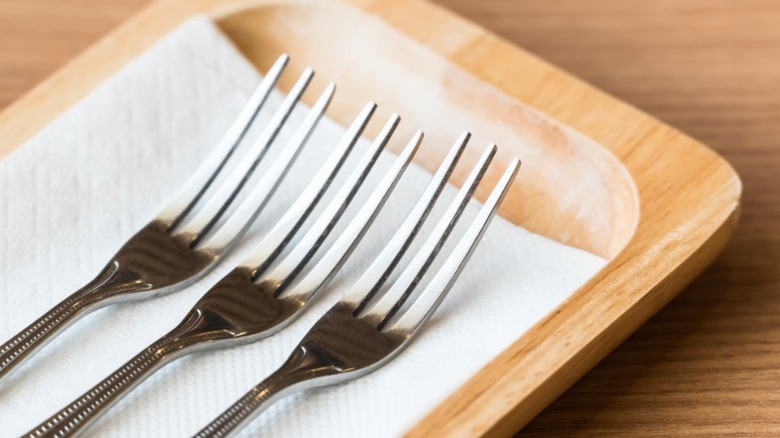 Three forks with three tines.