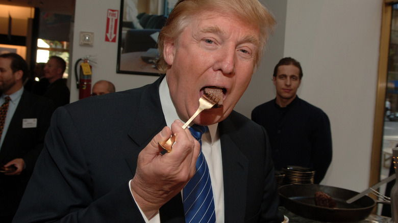 Donald Trump bites into a piece of steak