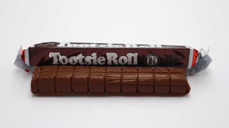 A Tootsie Roll, wrapped and unwrapped.