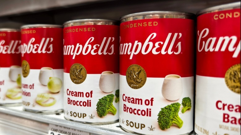 Close-up of Campbell's soup cans on store shelf