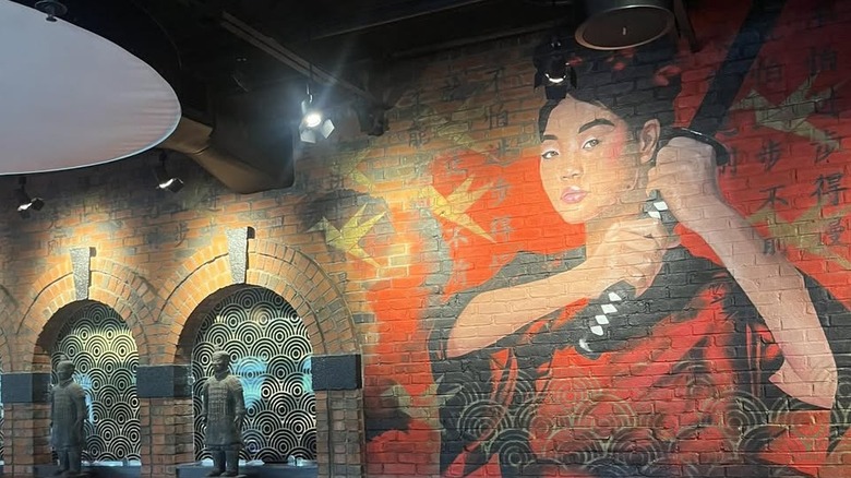 P.F. Chang's mural of a woman in red with black hair holding a sword