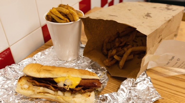 A Five Guys hot dog with fries (in cup and in bag)