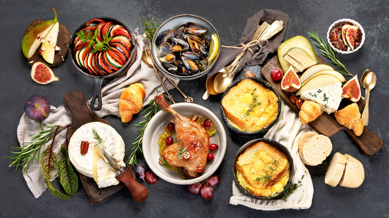 French food assortment on dark table.