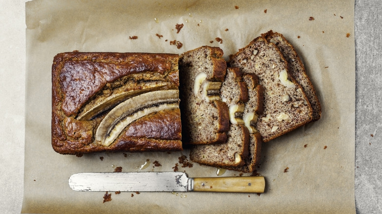 Overhead shot of a partially sliced banana bread loaf